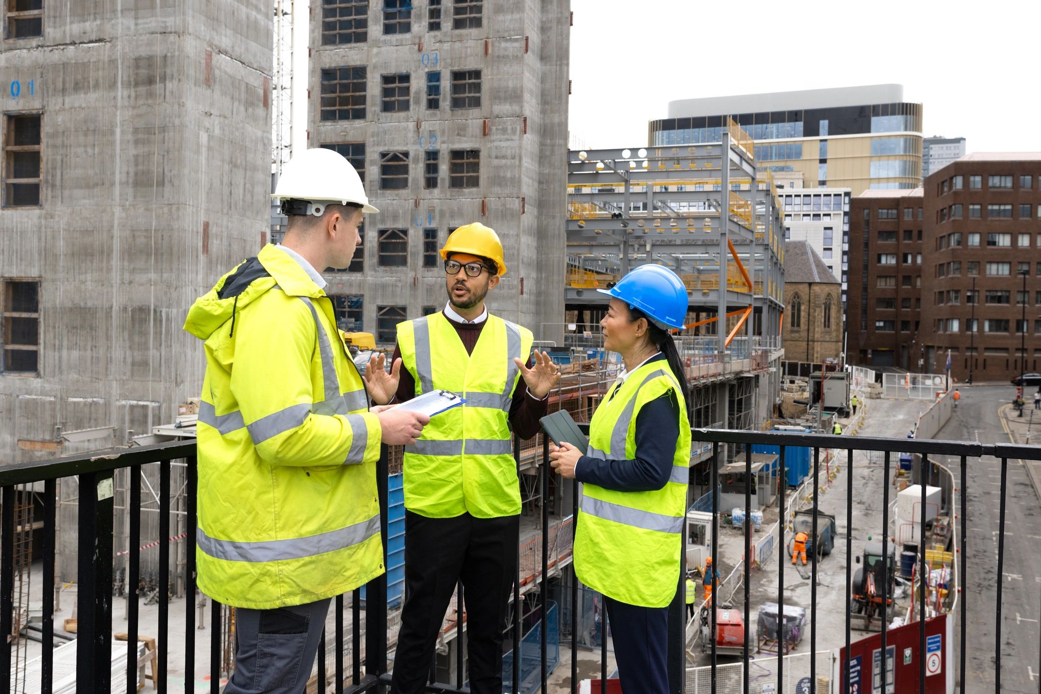 Construction and industrial team reviewing plans on site
