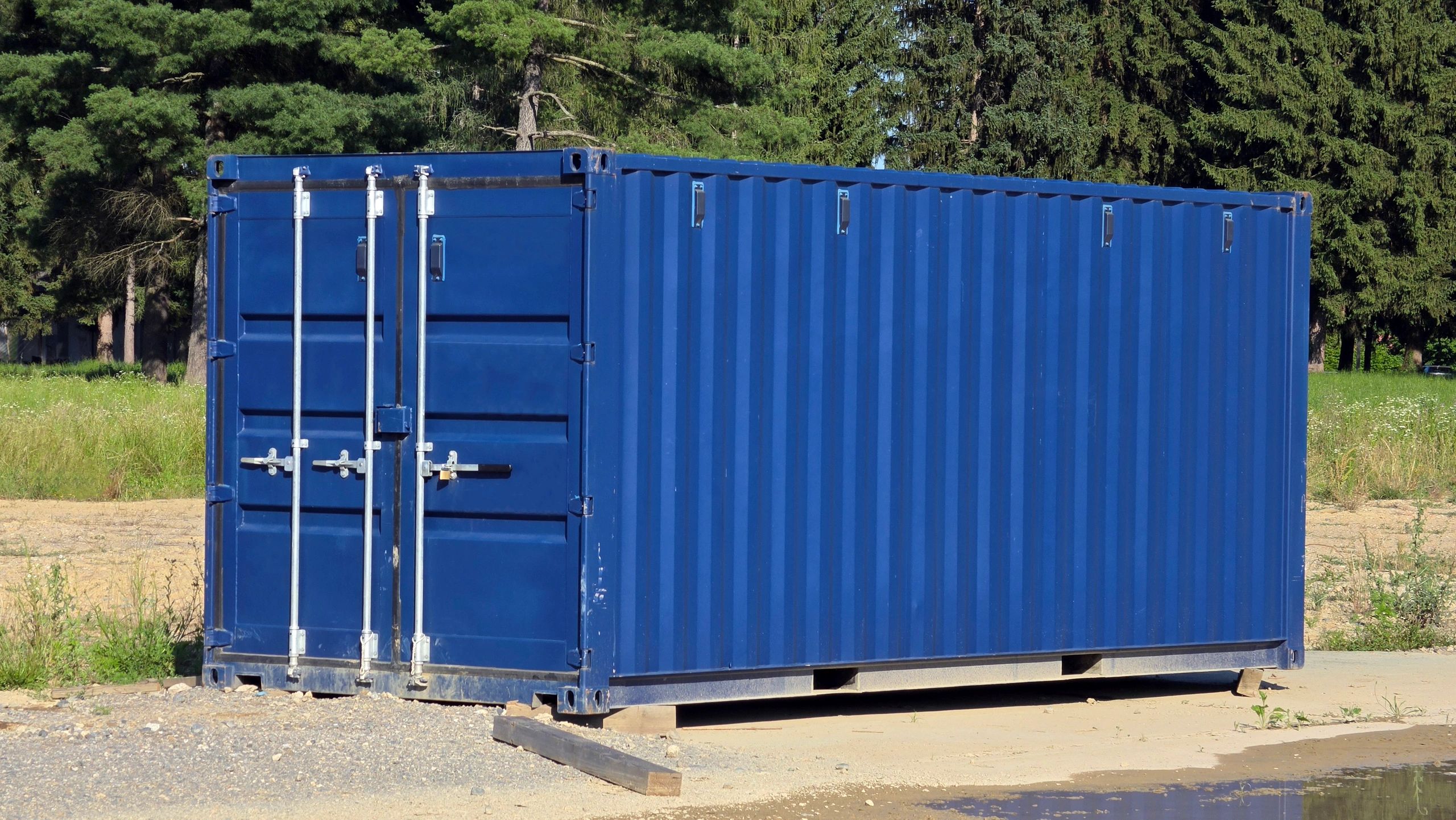 Blue metal shipping container on industrial lot