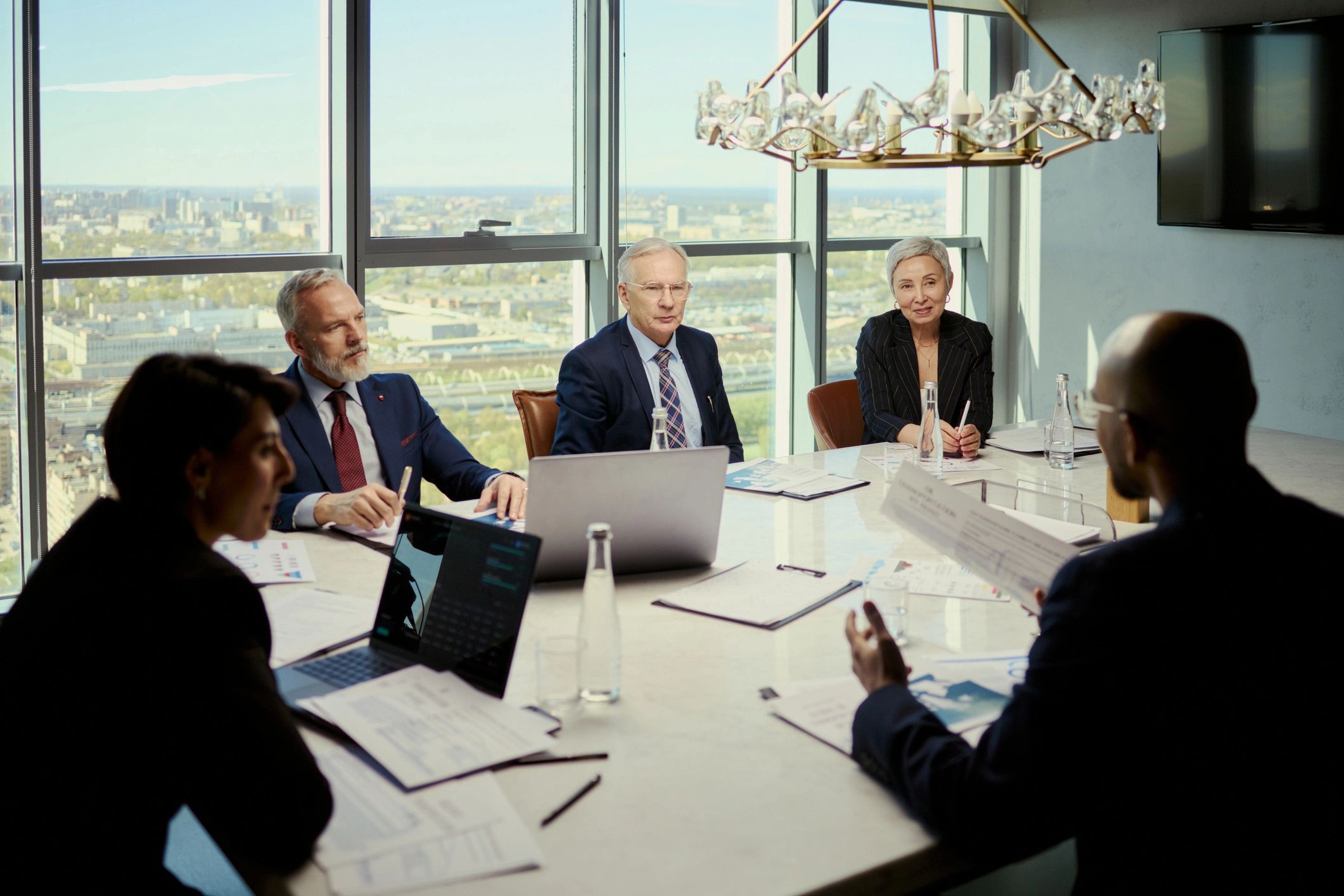 Business team discussing oil industry strategy in a boardroom